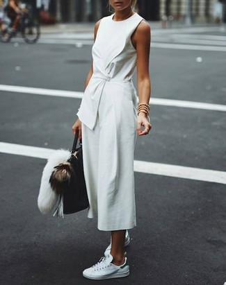 White and Black Low Top Sneakers Outfits For Women: Rock a white jumpsuit for a standout look. Look at how nice this outfit goes with a pair of white and black low top sneakers.