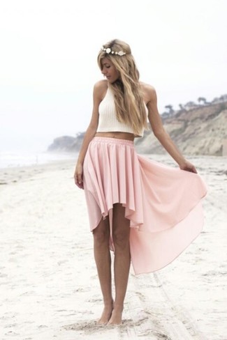Pink Pleated Midi Skirt Outfits: If you're in search of an off-duty and at the same time absolutely stylish outfit, team a white knit cropped top with a pink pleated midi skirt.