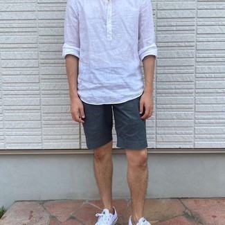 White Linen Long Sleeve Shirt Outfits For Men: A white linen long sleeve shirt and navy shorts have cemented themselves as absolute wardrobe heroes. White canvas low top sneakers are a good option to finish off this look.