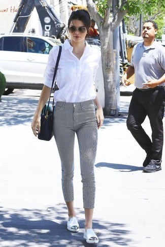 Kendall Jenner wearing Black Leather Crossbody Bag, White Leather Loafers, Grey Skinny Pants, White Dress Shirt