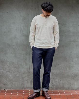 Long Sleeve Henley Shirt Outfits For Men: A long sleeve henley shirt and navy chinos are a combination that every stylish guy should have in his off-duty wardrobe. Here's how to breathe an extra touch of style into this look: dark brown leather casual boots.