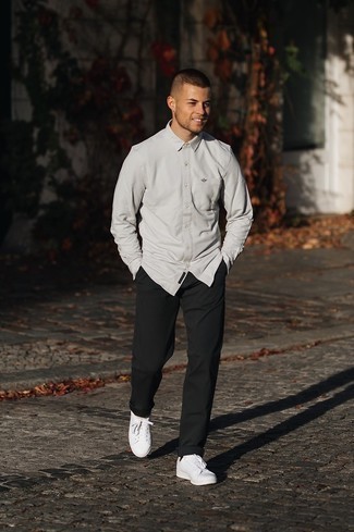 White Long Sleeve Shirt Outfits For Men: This casual combination of a white long sleeve shirt and black chinos can only be described as incredibly stylish. Change up your getup by wearing a pair of white canvas low top sneakers.
