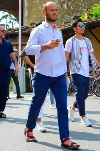 Purple Canvas Sandals Outfits For Men: Reach for a white long sleeve shirt and blue chinos for a straightforward ensemble that's also pulled together nicely. Infuse a hint of stylish casualness into this look by rounding off with a pair of purple canvas sandals.