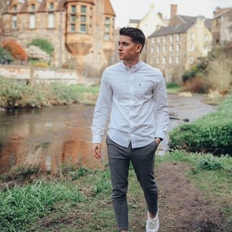 Charcoal Check Chinos Outfits: Pair a white long sleeve shirt with charcoal check chinos to achieve a casual and cool outfit. White canvas low top sneakers tie the ensemble together.