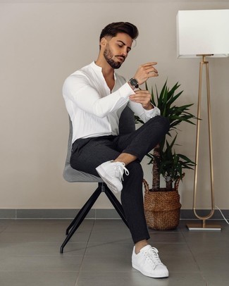 Charcoal Vertical Striped Chinos Outfits: The versatility of a white long sleeve shirt and charcoal vertical striped chinos means you'll always have them on constant rotation. A pair of white leather low top sneakers looks great here.