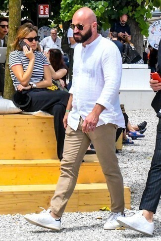 Beige Chinos Hot Weather Outfits: For an ensemble that offers function and dapperness, marry a white linen long sleeve shirt with beige chinos. And if you wish to instantly dial down your ensemble with one single item, why not throw white leather low top sneakers into the mix?