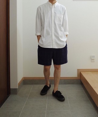 Navy Check Shorts Outfits For Men: A white long sleeve shirt and navy check shorts are great menswear essentials that will integrate brilliantly within your off-duty lineup. Let your styling chops truly shine by complementing your ensemble with black canvas low top sneakers.