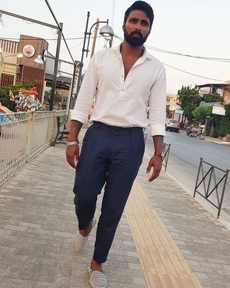 Navy Canvas Espadrilles Outfits For Men: This combo of a white long sleeve shirt and navy dress pants can only be described as incredibly sharp and sophisticated. Dial up this whole outfit by rounding off with navy canvas espadrilles.