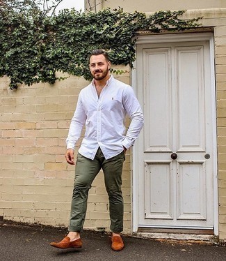Tobacco Suede Loafers Outfits For Men: The mix-and-match capabilities of a white long sleeve shirt and olive chinos guarantee you'll have them on high rotation in your closet. And if you need to instantly dial up this look with a pair of shoes, complete this outfit with tobacco suede loafers.