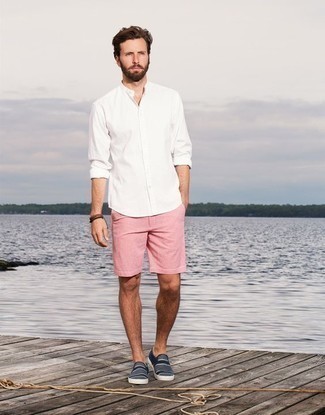 Hot Pink Shorts Outfits For Men: This pairing of a white long sleeve shirt and hot pink shorts is extremely versatile and up for whatever the day throws at you. A pair of navy and white horizontal striped canvas slip-on sneakers looks awesome finishing off your ensemble.