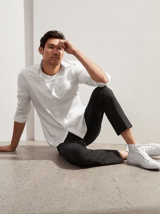 Black and White Chinos with High Top Sneakers Warm Weather Outfits: This combo of a white long sleeve shirt and black and white chinos is on the casual side yet it's also sharp and extra stylish. Send this ensemble in a more relaxed direction by finishing with high top sneakers.