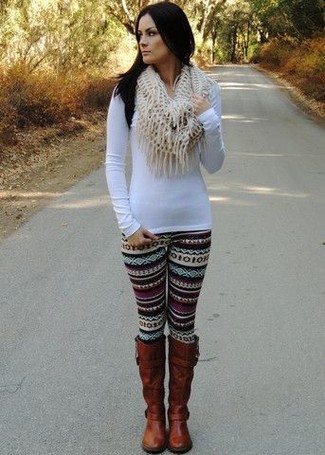 This outfit with a white long sleeve t-shirt and black fair isle leggings isn't so hard to pull off and leaves room to more sartorial experimentation. Switch up your look with a smarter kind of footwear, such as these brown leather knee high boots.