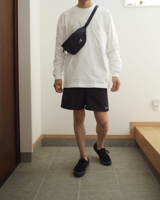 Black Sports Shorts Outfits For Men: If you feel more confident wearing something practical, you'll love this off-duty pairing of a white long sleeve t-shirt and black sports shorts. And if you wish to easily class up your getup with footwear, why not complement this getup with a pair of black canvas low top sneakers?