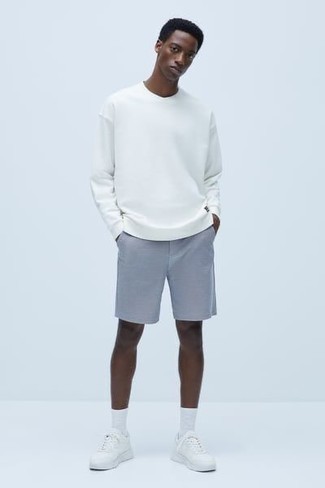 500+ Summer Outfits For Men: A white long sleeve t-shirt and light blue shorts are a cool combination to carry you throughout the day and into the night. For a more laid-back vibe, add a pair of white athletic shoes to your outfit. You're guaranteed to always look stylish even despite the scorching heat if you keep this getup as your go-to formula.