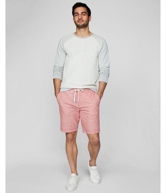 Hot Pink Shorts Outfits For Men: If you like casual combos, why not take this pairing of a white long sleeve t-shirt and hot pink shorts for a spin? When it comes to shoes, this ensemble pairs wonderfully with white leather low top sneakers.