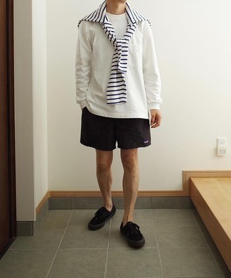 121 Relaxed Outfits For Men: A white and navy horizontal striped long sleeve t-shirt and black sports shorts are a great look to have in your day-to-day lineup. And if you need to immediately level up your look with a pair of shoes, finish with black canvas low top sneakers.