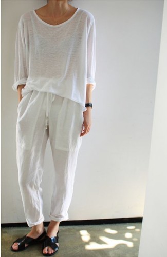 White Pajama Pants Outfits For Women: This off-duty combination of a white long sleeve t-shirt and white pajama pants can take on different moods according to the way you style it. A pair of black leather flat sandals easily amps up the street cred of your getup.