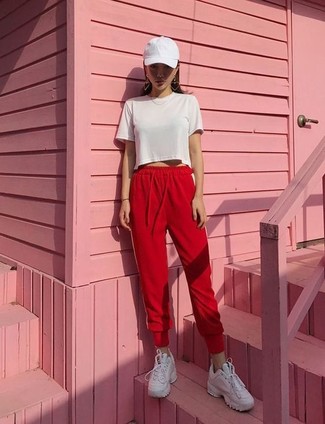 Women's White Cap, White Leather Low Top Sneakers, Red Sweatpants, White Cropped Top
