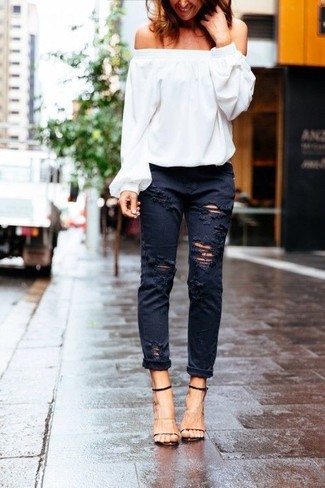 Grey Ripped Jeans Outfits For Women: The combo of a white off shoulder top and grey ripped jeans makes for a solid relaxed casual getup. If you want to effortlessly class up this ensemble with a pair of shoes, why not complete your outfit with a pair of black and tan leather heeled sandals?