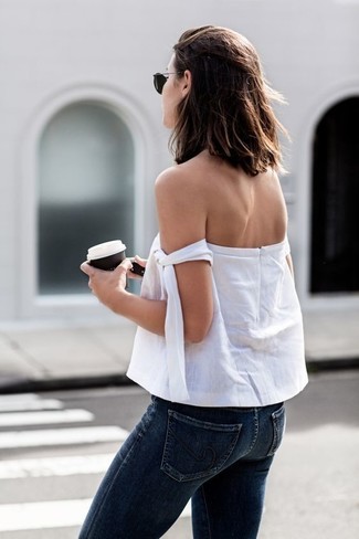 White Off Shoulder Top Outfits: This pairing of a white off shoulder top and navy skinny jeans embodies comfort without compromising style.