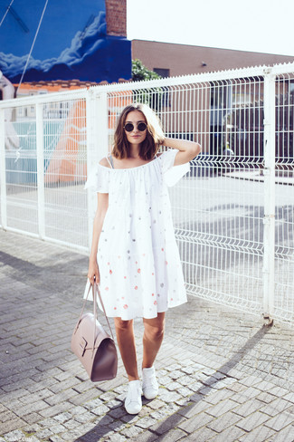 White Low Top Sneakers Outfits For Women: For a casual getup with a modern take, you can always rely on a white polka dot off shoulder dress. All you need now is a pair of white low top sneakers to complete this outfit.