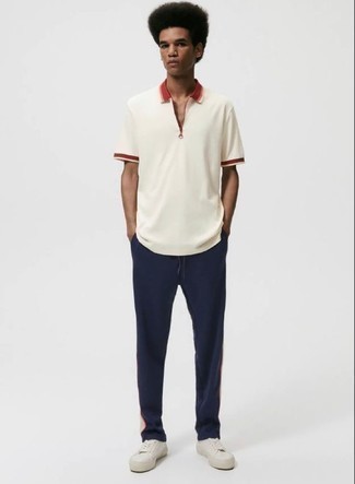 White Canvas Low Top Sneakers Outfits For Men: If you’re a jeans-and-a-tee kind of guy, you'll like this basic combo of a white polo and navy sweatpants. Let your sartorial prowess really shine by finishing off your look with a pair of white canvas low top sneakers.