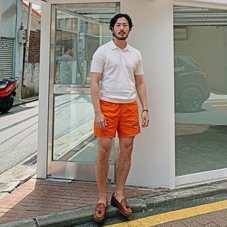Mustard Sports Shorts Outfits For Men: A white polo and mustard sports shorts married together are a sartorial dream for gents who prefer laid-back and cool ensembles. Introduce a pair of brown leather tassel loafers to this getup to instantly jazz up the getup.
