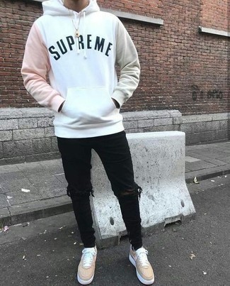 White Print Hoodie Outfits For Men: This casual combination of a white print hoodie and black ripped skinny jeans is a goofproof option when you need to look nice in a flash. Tan leather low top sneakers will infuse a dose of sophistication into an otherwise mostly dressed-down outfit.