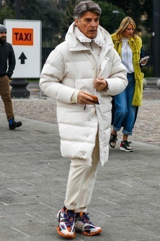 Men's Outfits 2024: Inject variety into your current casual wardrobe with a white puffer coat and beige chinos. Go down the casual route with footwear by finishing off with a pair of multi colored athletic shoes.