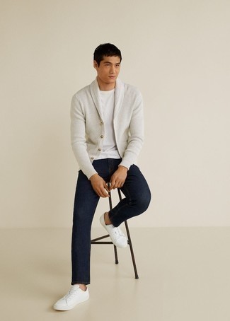 White Cardigan Outfits For Men: To don an off-duty ensemble with a modern spin, team a white cardigan with navy jeans. For times when this getup is just too much, dress it down by finishing with a pair of white canvas low top sneakers.