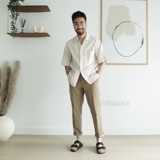 Black Leather Sandals Outfits For Men: Pair a white short sleeve shirt with khaki chinos for a killer getup. To infuse an element of stylish effortlessness into this look, complement your outfit with a pair of black leather sandals.