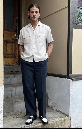 Navy Chinos Outfits: A white short sleeve shirt and navy chinos worn together are a great match. To give your overall ensemble a more polished finish, introduce black and white leather loafers to this look.