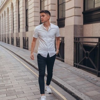 White Vertical Striped Short Sleeve Shirt Outfits For Men: A white vertical striped short sleeve shirt and navy chinos are essential in any modern man's properly coordinated casual sartorial collection. For a more casual feel, why not add white athletic shoes to the equation?