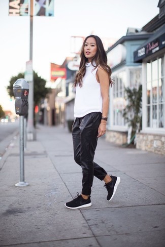 Black and White Athletic Shoes Outfits For Women: This casual combo of a white sleeveless turtleneck and black leather sweatpants is effortless, incredibly chic and oh-so-easy to replicate! For something more on the daring side to complete your outfit, complement your outfit with black and white athletic shoes.