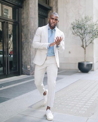 White Suit with White Canvas Low Top Sneakers Outfits: This refined combo of a white suit and a light blue dress shirt will be a good indication of your sartorial savvy. Complement this look with white canvas low top sneakers to give a touch of stylish casualness to this getup.