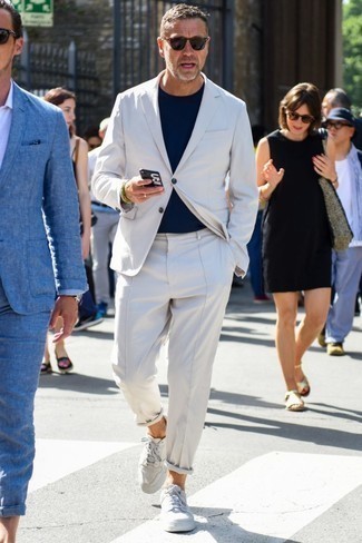 White Suit Outfits: Putting together a white suit with a white crew-neck t-shirt is an on-point idea for a semi-casual getup. Feeling experimental? Tone down this look with white leather low top sneakers.