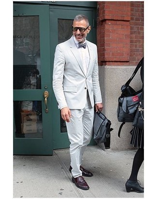 Channel your inner Kingsman agent and marry a white suit with a white dress shirt. If you want to immediately dress down your ensemble with one single piece, add burgundy leather derby shoes to the equation.