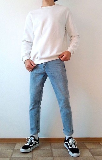 White Sweatshirt Outfits For Men: Pair a white sweatshirt with light blue jeans if you want to look casual and cool without exerting much effort. If not sure about what to wear in the shoe department, go with black and white canvas low top sneakers.