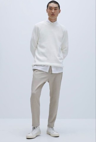 White Canvas High Top Sneakers Outfits For Men: Choose a white sweatshirt and beige chinos for a casual outfit with a modern take. Introduce white canvas high top sneakers to the equation to infuse a touch of stylish nonchalance into this outfit.