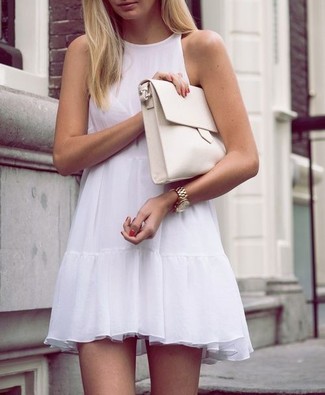 White Leather Clutch Outfits: If you're hunting for a casual and at the same time seriously chic getup, consider pairing a white swing dress with a white leather clutch.