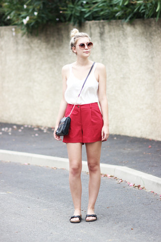 Red Shorts Outfits For Women: Try teaming a white tank with red shorts to get a laid-back yet stylish ensemble. Bring a touch of stylish casualness to your ensemble by slipping into a pair of black leather flat sandals.