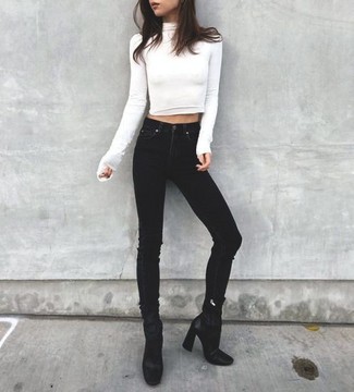 Black Leather Ankle Boots Outfits: This pairing of a white turtleneck and black skinny jeans is undeniable proof that a safe casual outfit can still be really interesting. Complement this ensemble with a pair of black leather ankle boots and off you go looking amazing.