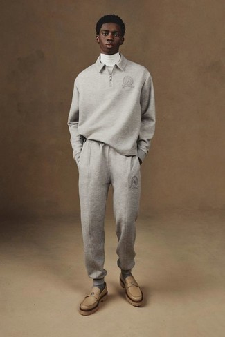 Track Suit Outfits For Men: If you put practicality above all, this off-duty combo of a track suit and a white turtleneck is your go-to. You could go down a more elegant route when it comes to footwear by sporting a pair of tan leather loafers.