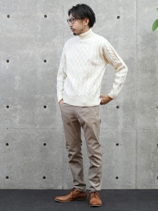 White Knit Wool Turtleneck Outfits For Men: Who said you can't make a fashion statement with a casual getup? Draw the attention in a white knit wool turtleneck and khaki chinos. Complete your look with brown leather derby shoes to instantly spice up the look.