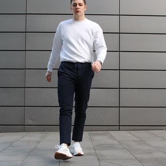 White and Navy Sweater Outfits For Men: This pairing of a white and navy sweater and navy chinos looks awesome and makes any guy look instantly cooler. Complement your getup with white athletic shoes and off you go looking smashing.
