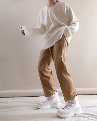 White and Black High Top Sneakers Outfits For Men: For a casually dapper ensemble, pair a white v-neck sweater with khaki chinos — these items work nicely together. Complement this outfit with a pair of white and black high top sneakers to make a traditional ensemble feel suddenly fresh.