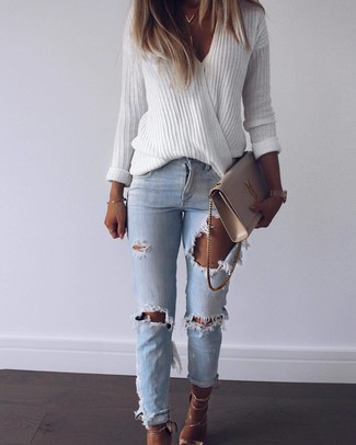 Light Blue Ripped Jeans Outfits For Women: If you're on the lookout for a laid-back and at the same time totaly stylish getup, go for a white v-neck sweater and light blue ripped jeans. Complement this look with gold leather heeled sandals to completely spice up the getup.
