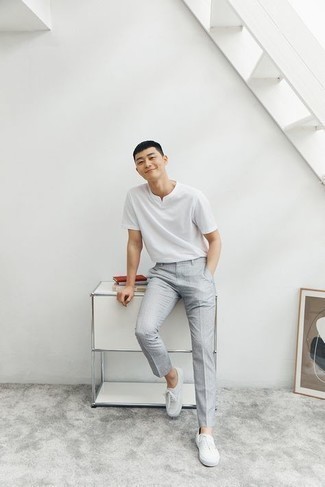 Grey Chinos Outfits: You'll be amazed at how easy it is for any gent to get dressed like this. Just a white v-neck t-shirt and grey chinos. On the shoe front, this ensemble is rounded off really well with white canvas low top sneakers.