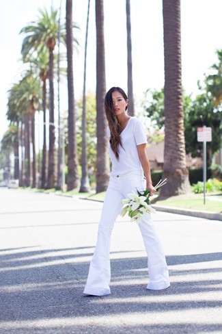 V-neck T-shirt Outfits For Women: This pairing of a v-neck t-shirt and white flare jeans will hallmark your sartorial prowess even on lazy days.