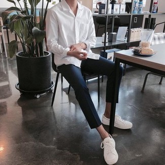 White Vertical Striped Long Sleeve Shirt Outfits For Men: If you need to go about your day with confidence in your ensemble, try pairing a white vertical striped long sleeve shirt with navy chinos. Complete your ensemble with white leather low top sneakers et voila, your look is complete.